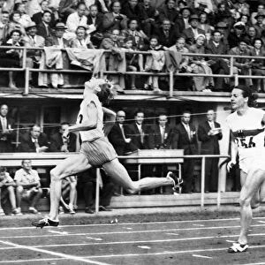 SUMMER OLYMPICS, 1952. Fanny Blankers-Koen of the Netherlands beating Marga Petersen of Germany in the 11th heat of the 100 meter dash event in the 1952 Summer Olympics in Helsinki, Finland