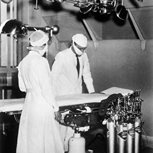 SURGEONS, c1930. Surgeons in an operating room. Photograph, c1930
