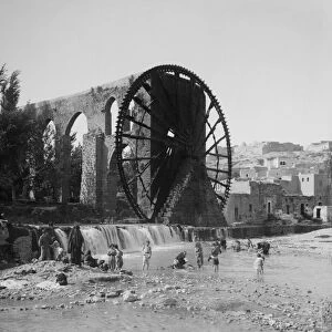 SYRIA: AQUEDUCT, c1910. A noria and aqueduct on the Orontes River in Hama, Syria