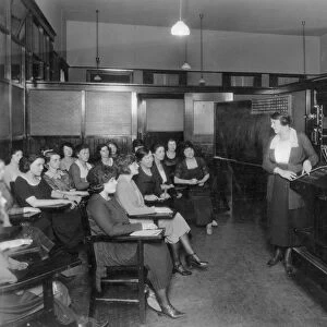 TELEPHONE EXCHANGE, 1915. A telephone company switchboard training class, c1915