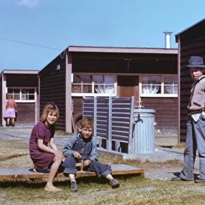 TEXAS: FSA LABOR CAMP, 1942. Boy building a model airplane while other children look