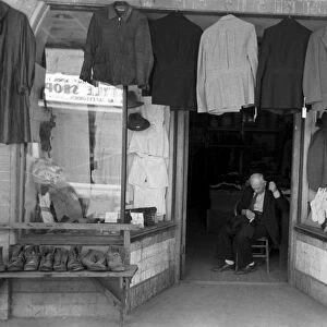 TEXAS: STOREFRONT, 1939. Clothing store with a tailor in the doorway, Mexican district