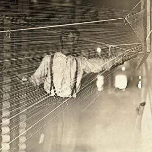 TEXTILE MILL, 1908. A warper at his machine in a cotton mill in Newton, North Carolina