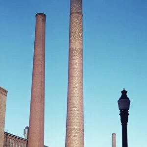 TEXTILE SMOKESTACKS, 1941. Large textile mill smokestacks in Lowell, Massachusetts