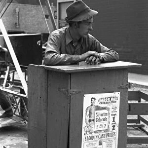 TICKET SELLER, 1940. Selling tickets for the ferris wheel ride at the Labor Day