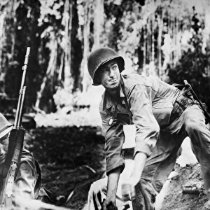 U. S. Army soldier prepares to throw a hand grenade during the fighting at Empress Augusta Bay, Bougainville, New Guinea. Photographed late 1943