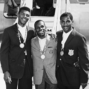 U. S. BOXING TEAM, 1960. The American Olympic boxing team and gold medal winners, left to right: Muhammad Ali (nÔÇÜ Cassius Clay), Eddie Crook and Willie McClure, photographed at Idlewild airport in New York on their return to America after the 1960 Summer Olympics in Rome, Italy
