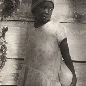 ULMANN: GIRL, c1930. Portrait of a young girl holding a bag. Platinum print by Doris Ulmann
