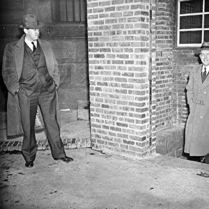 UNIDENTIFIED MEN, c1920. Unidentified men wearing suits in an alleyway. Photograph