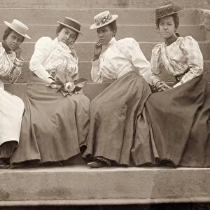 UNIVERSITY STUDENTS, c1900. Four African American students seated on the steps