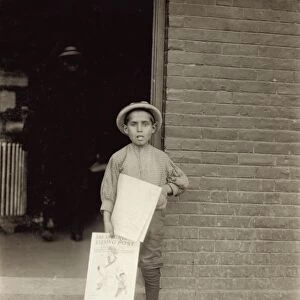VERMONT: NEWSBOY, 1910. A young newsboy at a depot in Burlington, Vermont
