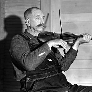 VIRGINIA: FIDDLER, 1934. Davy Crockett Ward, a fiddler with the Bog Trotters Band