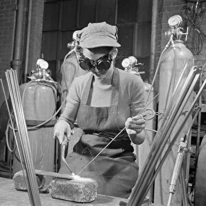 WELDING STUDENT, 1942. Young woman learning to weld at a vocational school, United States