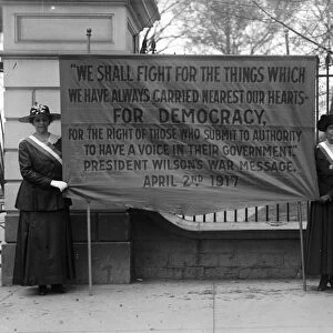 WHITE HOUSE: SUFFRAGETTES. Women suffragettes holding a banner addressing President Woodrow Wilson, in front of the White House, Washington, D. C. 1917
