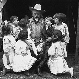 WILLIAM F. CODY (1846-1917). William Frederick Cody, known as Buffalo Bill. American frontiersman and showman, photographed with a group of children, c1913