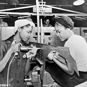 Two women at work at the Douglas Aircraft Company factory in California, during World War II
