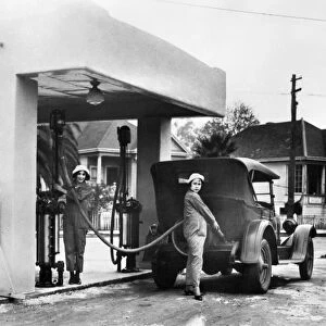 Two women working at a gas station in California. Photograph, c1925