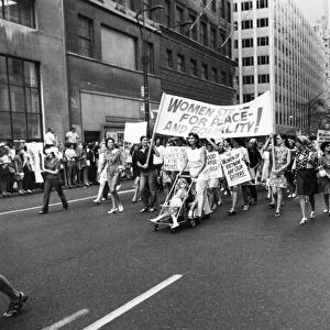WOMENs RIGHTS, 1970. Women marching down New Yorks Fifth Avenue, 26 August 1970, in support of the Womens Liberation Movement, here carrying banners saying Women Strike for Peace (in Vietnam) and Equality