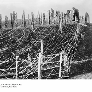 WORLD WAR I: BARBED WIRE. German soldiers fixing a barbed wire tangle on a battlefield during World War I, 1914-18