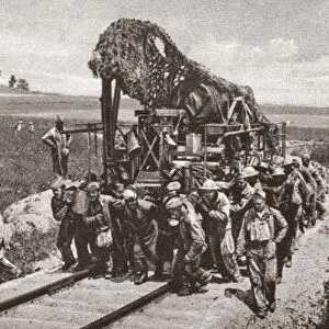 WORLD WAR I: CAMOUFLAGE. A heavy French gun covered in camouflage being transported