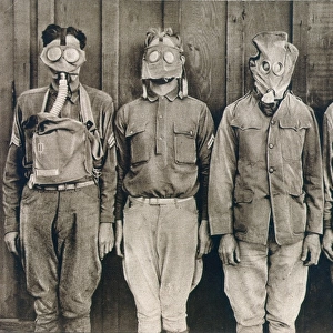 WORLD WAR I: GAS WARFARE. American soldiers demonstrating the different types of gas masks worn by (left to right) U. S. British, French, and German troops