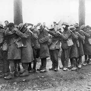 WORLD WAR I: GAS WARFARE. British soldiers blinded by a German gas attack during the Lys offensive shuffle toward an advanced dressing station near Bethune, France, April 1918