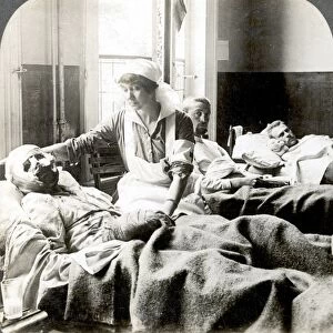 WORLD WAR I: NURSE. A nurse tending to a badly wounded soldier at a hospital in Antwerp, Belgium, during World War I, 1914