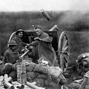 WORLD WAR I: U. S. ARTILLERY. An American gun crew fires a 75mm gun at Saint-Mihiel, France. Photograph, September 1918