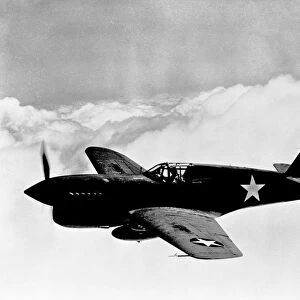 WORLD WAR II: KITTYHAWK. A P-40 single-engine fighter plane in flight, called Kittyhawk