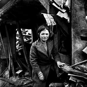 WORLD WAR II: V-2 ATTACK. A girl standing amid the ruins in Battersea, London, England
