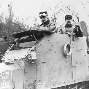 WWI: ARMORED CAR, c1915. Two soldiers in an armored car, possibly in France. Photograph