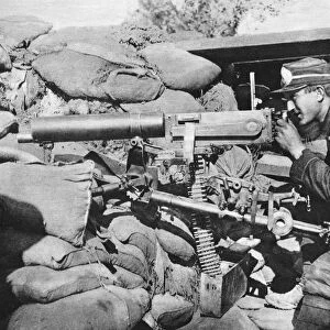 WWI: BELGIAN GUNNER. A Belgian gunner operating a maxim machine gun during World War I