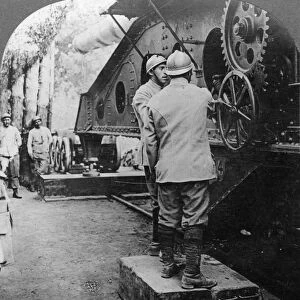 WWI: FRENCH GUNNERS, c1915. French gunners adjusting large cannon mounted on railway