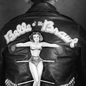 WWII: BOMBER JACKET, 1944. Leather jacket worn by the crew members of the Boeing B-17 Flying Fortress Belle O the Brawl of the 401st Bomb Group. Photograph, 1944