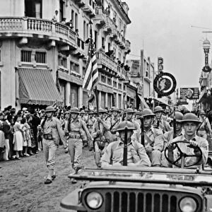 WWII: GUATEMALA, 1942. American troops on parade up Sixth Avenue in Guatemala City, Guatemala