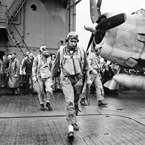WWII: PILOT, c1943. An American pilot on the deck of an aircraft carrier. Photograph