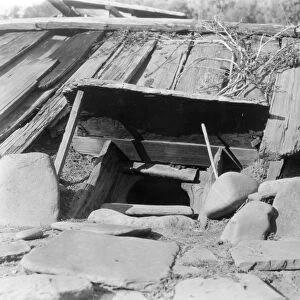YUROK SWEAT LODGE, c1923. A sweat lodge, an underground building surrounded by