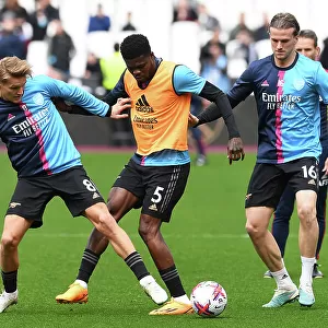 Arsenal Players Martin Odegaard, Thomas Partey, and Rob Holding Warm Up Ahead of West Ham United Match, Premier League 2022-23