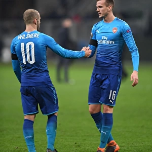 Arsenal's Holding and Wilshere Share a Moment after AC Milan Clash in Europa League