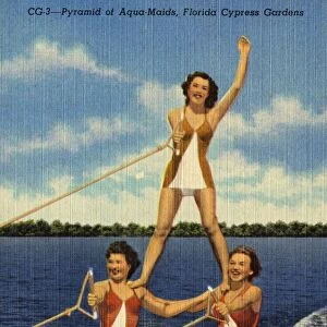 Aqua-Maids at Cypress Gardens. ca. 1949, Florida, USA, Its water skiing time in Florida and here three of the Cypress Gardens Aqua-Maids form a pyramid of beauty while skiing over the water at 30 miles per hour