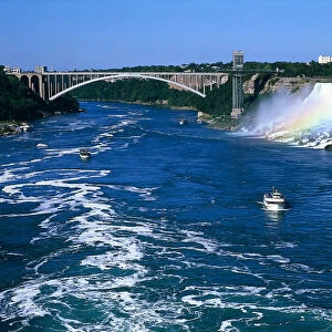 Canada, Ontario, rainbow over the Niagara Falls, with boats sailing down the Niagara river