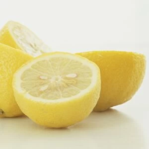 Citrus x Limon, Lemon, halved fresh lemons with pips and yellow rind visible