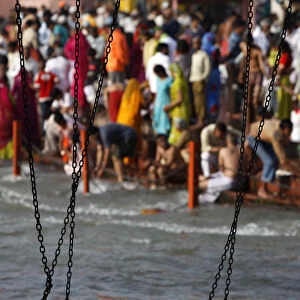 Devotees and holy men take a dip in the river Ganges during Lord Ramas day