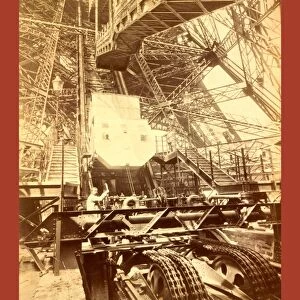 Eiffel Tower Machinery With A Man Beside The Wheel That Raises Elevator
