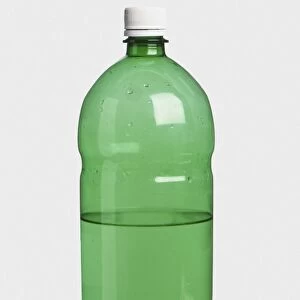 Half full green plastic bottle of water