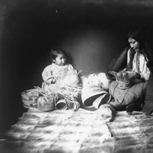 Indian woman and child weaving baskets