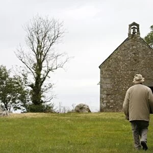 Man walking up to Mont-Dol chapel