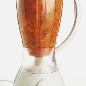 Orange-red mixture of vegetables in a blender
