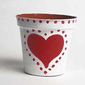 Empty plant pot painted with love heart and dots