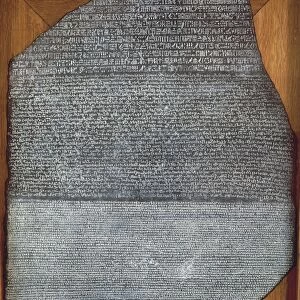 Rosetta Stone, with an inscription in three scripts: Egyptian hieroglyphs, Egyptian demotic script and Greek (top to bottom). Dark granite stone